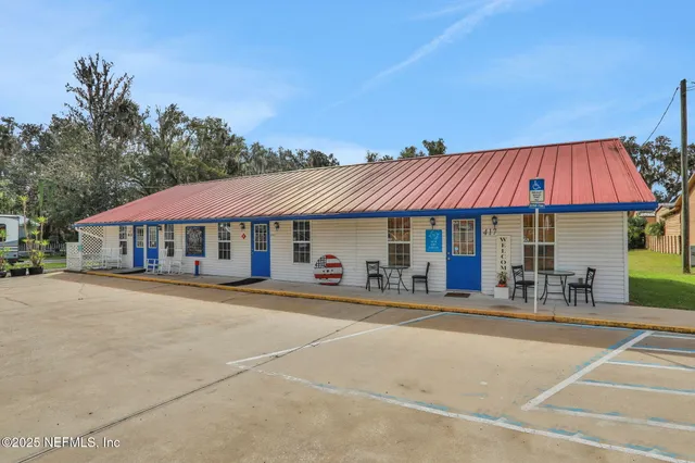 a patio with a table and chairs under an umbrella
