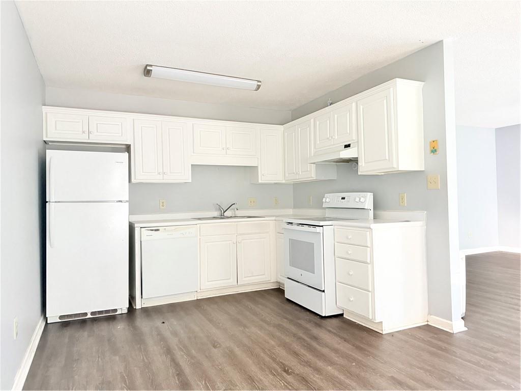 330 Peach Orchard Road Baldwin, GA 30531 - Photo 7 of 13 a kitchen with white cabinets and white appliances