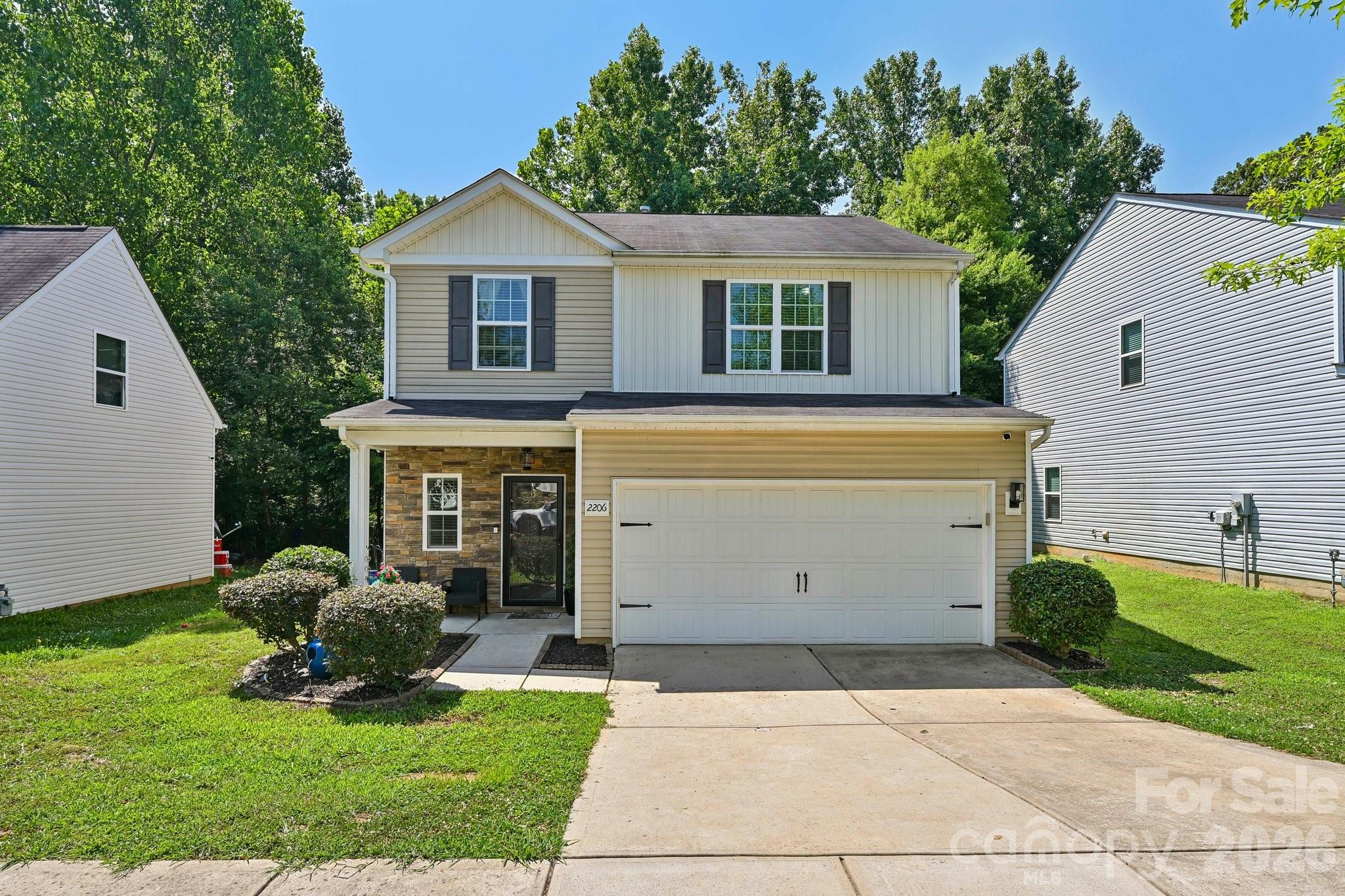 2206 Turtle Point Road Charlotte, NC 28262 - Photo 1 of 28 a front view of a house with garden