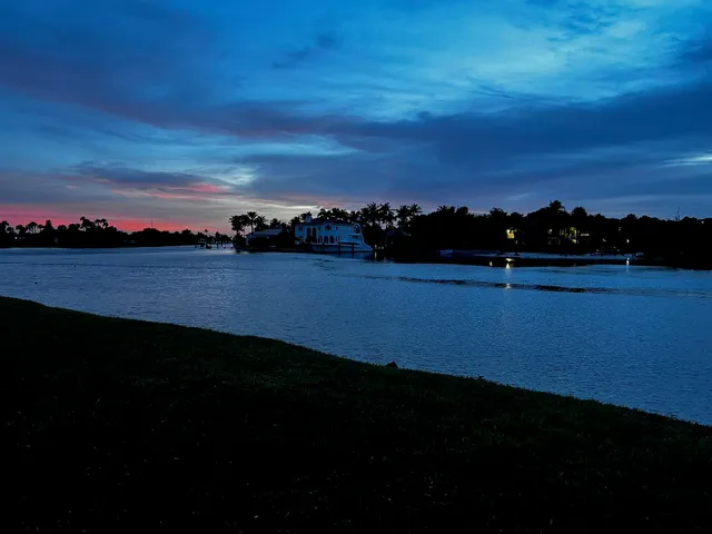 a view of a lake with houses in back