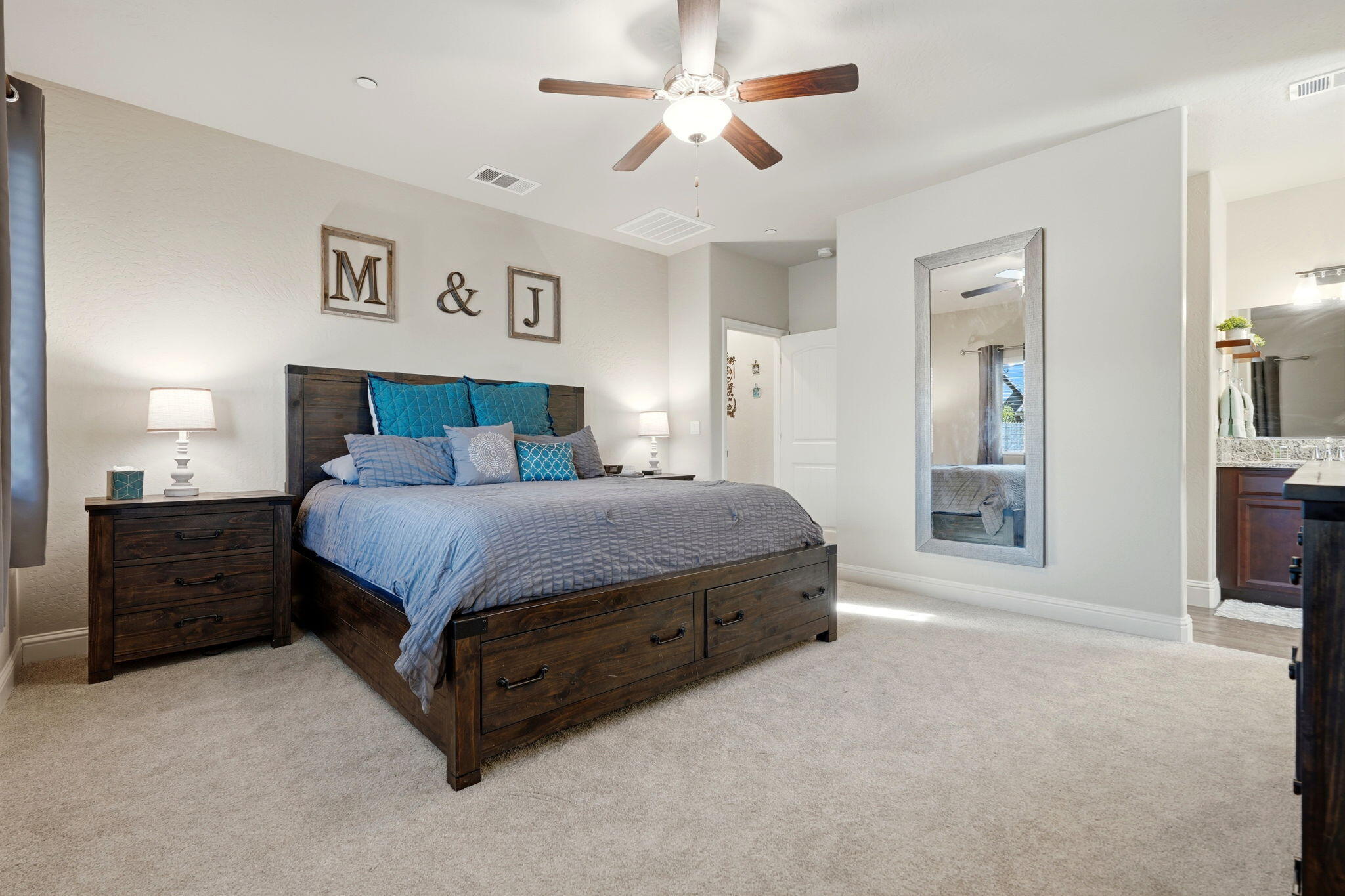 756 Strada Street Lemoore, CA 93245 - Photo 31 of 53 a spacious bedroom with a bed and a chandelier