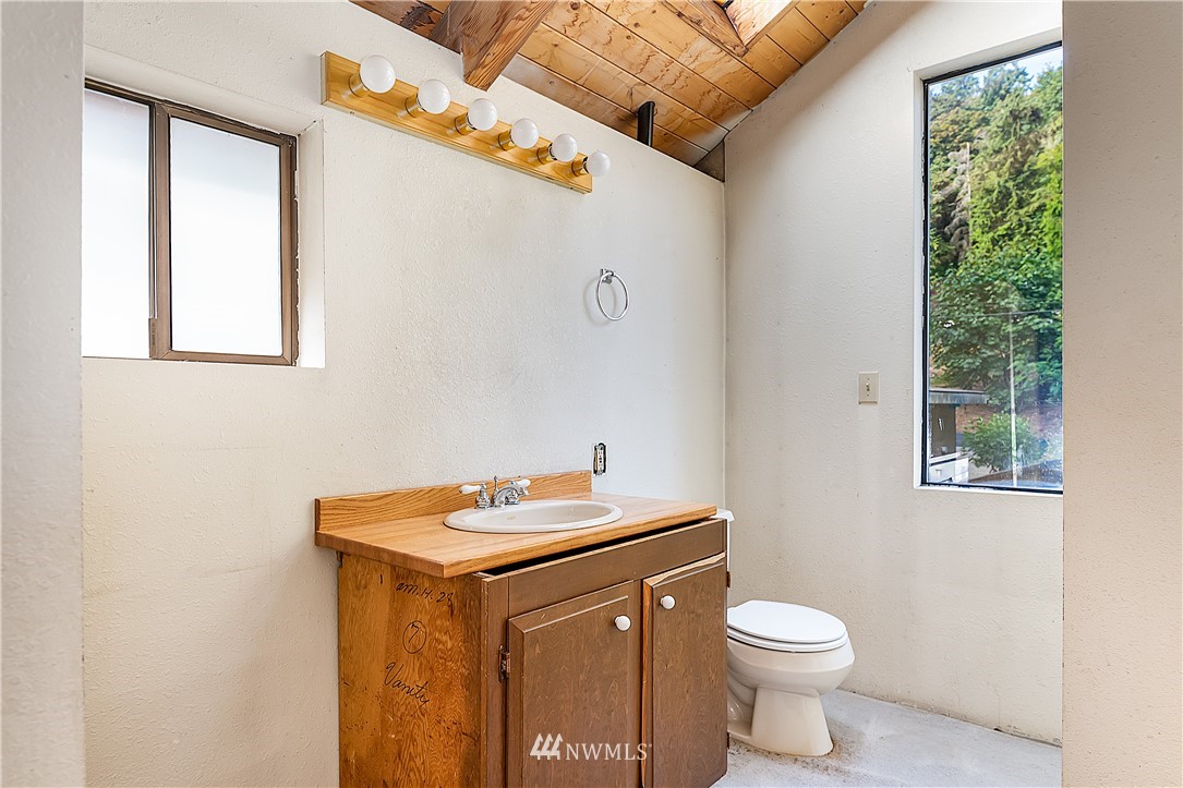 26430 Lake Fenwick Road South Kent, WA 98032 - Photo 14 of 30 a bathroom with a sink a toilet and a mirror
