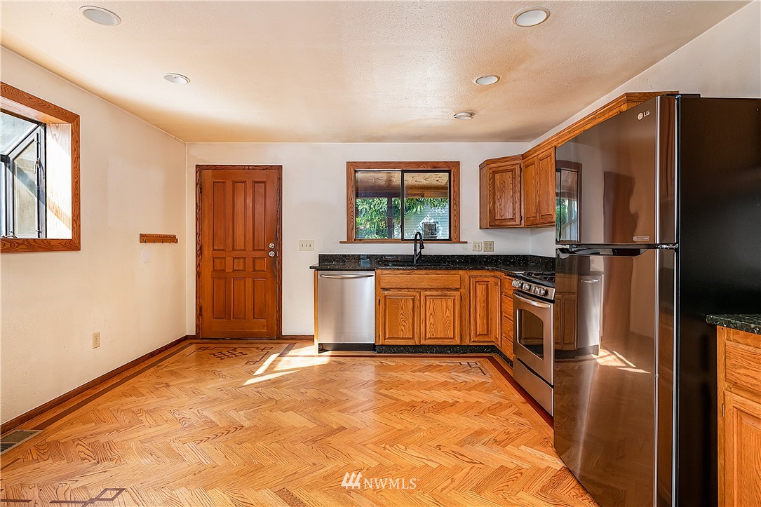 26430 Lake Fenwick Road South Kent, WA 98032 - Photo 8 of 30 a view of a kitchen with a sink and a refrigerator