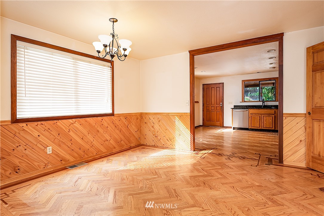 26430 Lake Fenwick Road South Kent, WA 98032 - Photo 10 of 30 a spacious bedroom with a large bed a chandelier and windows