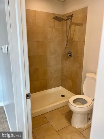 an empty room with wooden floor and cabinet