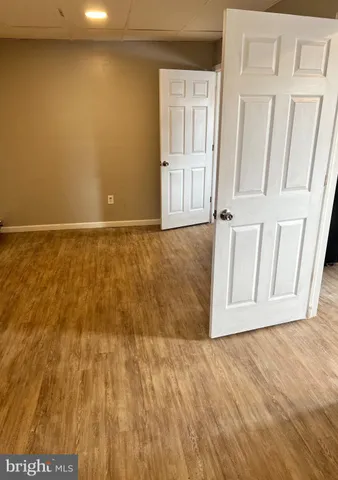 a room with wooden floor and glass door