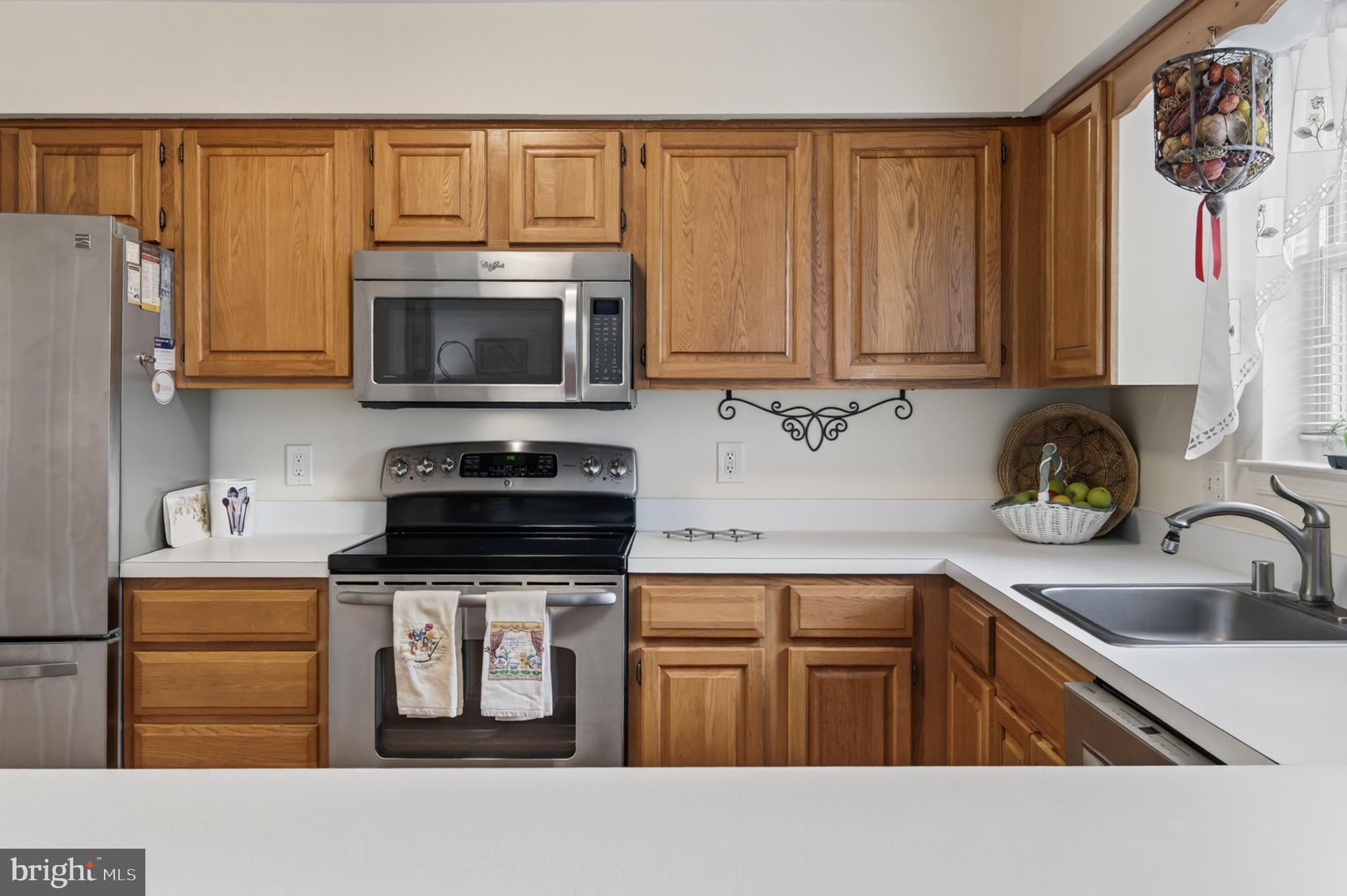 936 Bay Ridge Avenue, Unit 201 Annapolis, MD 21403 - Photo 27 of 40 a kitchen with stainless steel appliances granite countertop a stove a sink and a microwave