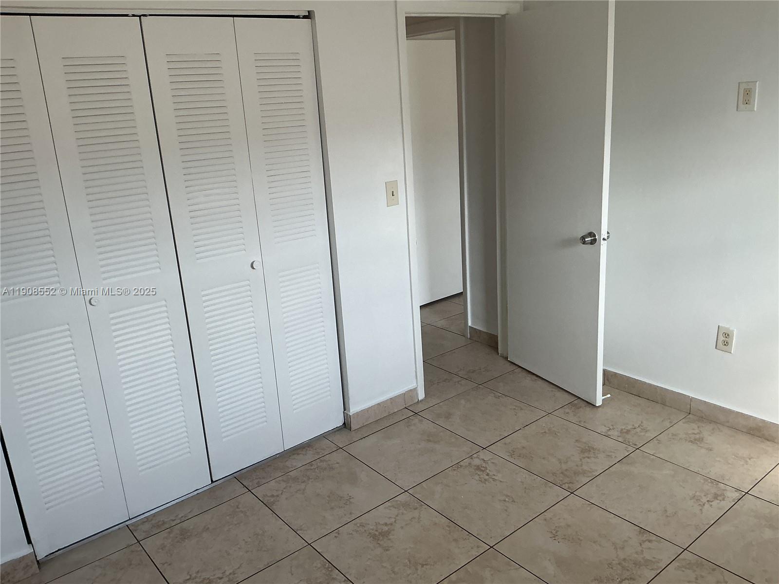 256 East 7th Street, Unit 202 Hialeah, FL 33010 - Photo 2 of 5 an empty room with windows