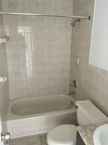 a bathroom with a bathtub and a toilet