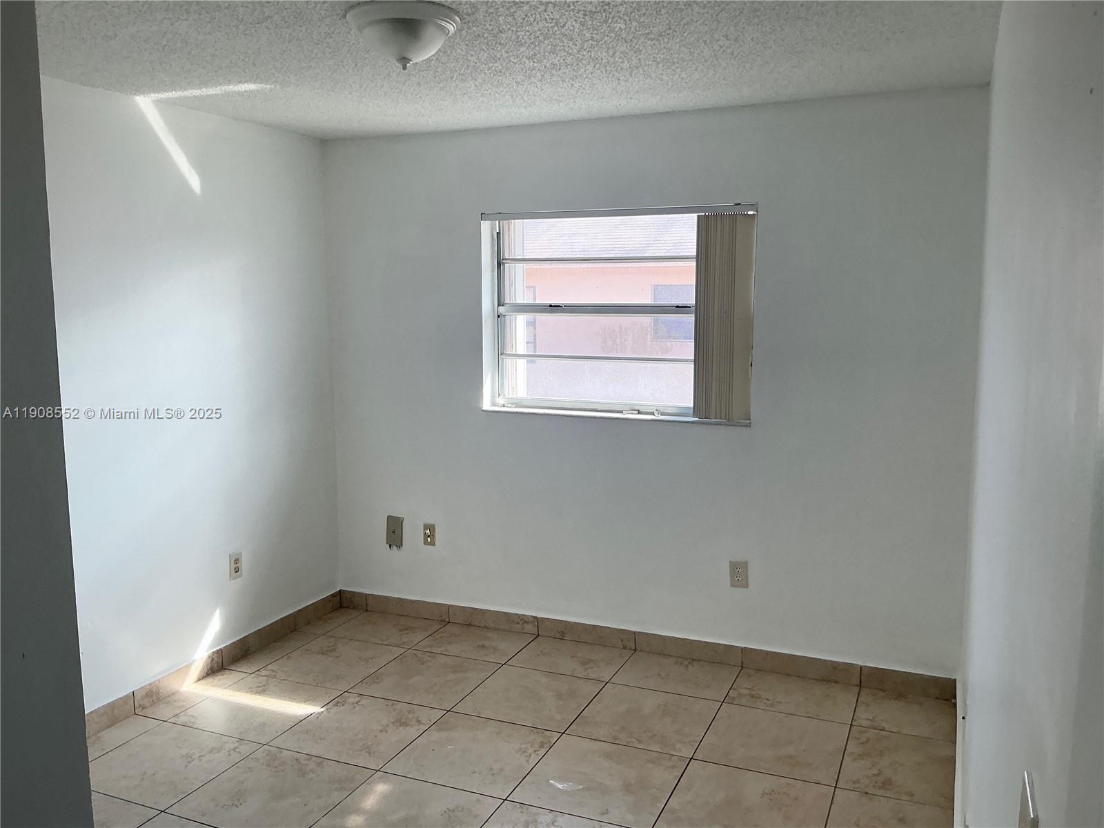 256 East 7th Street, Unit 202 Hialeah, FL 33010 - Photo 5 of 5 a view of a room that has a window in it