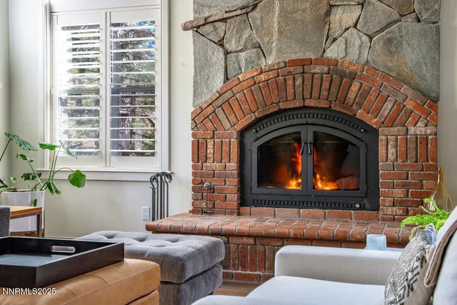 a living room with furniture a fireplace and a window