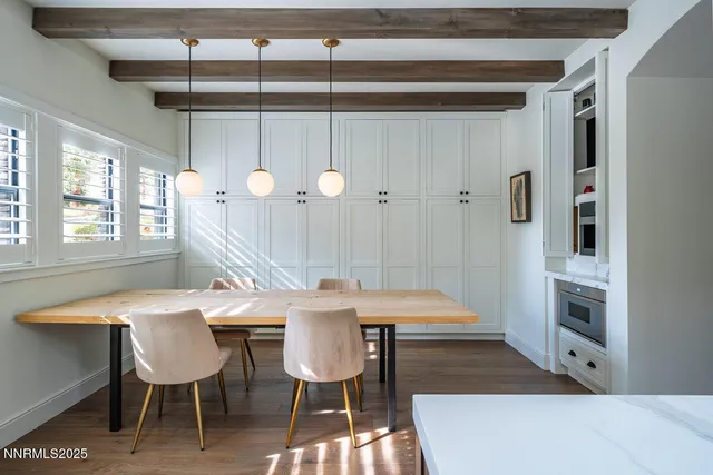 a dining room with a table chairs and a painting on the wall