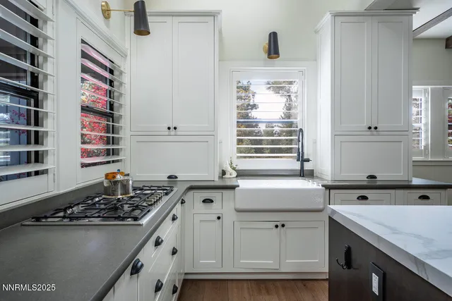 a kitchen with a sink stove and cabinets