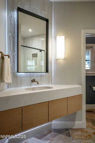 a bathroom with a sink and a mirror