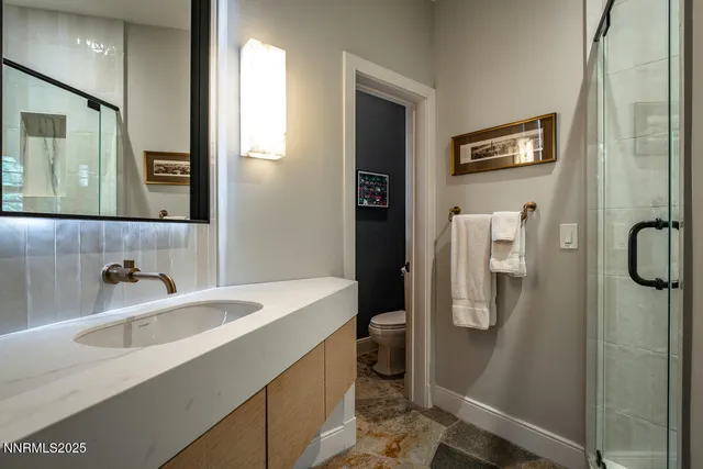 a bathroom with a sink toilet and shower