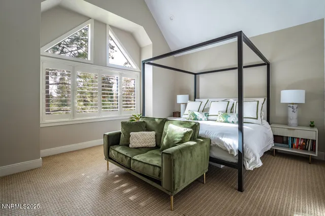 a bedroom with furniture and a large window