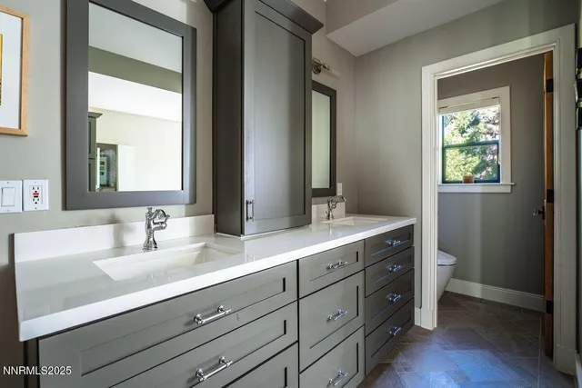a bathroom with a double vanity sink and a mirror