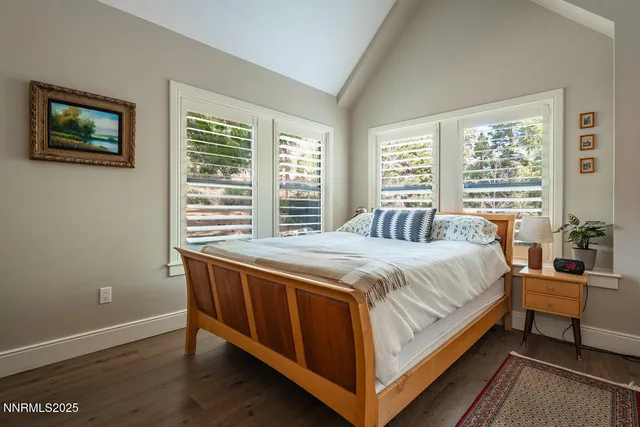 a bed sitting in a bedroom next to a window