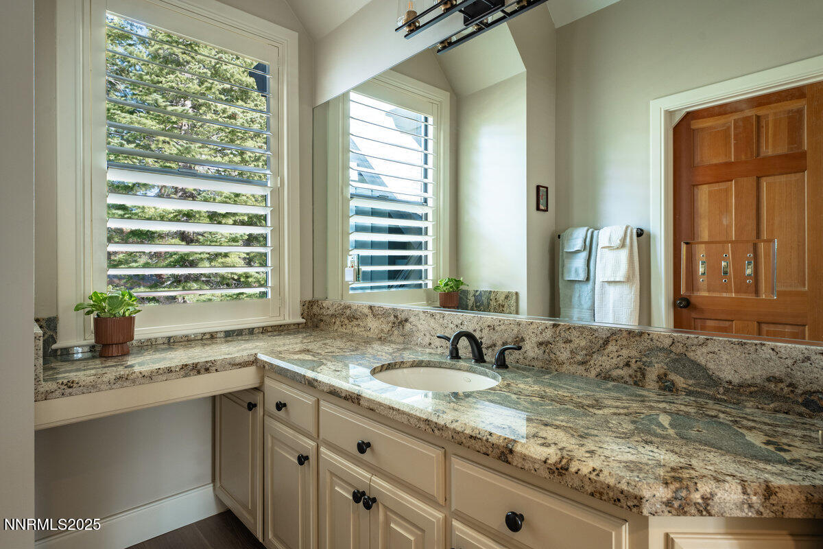 2 South Point Place Glenbrook, NV 89413 - Photo 34 of 49 a bathroom with a granite countertop sink and a large mirror