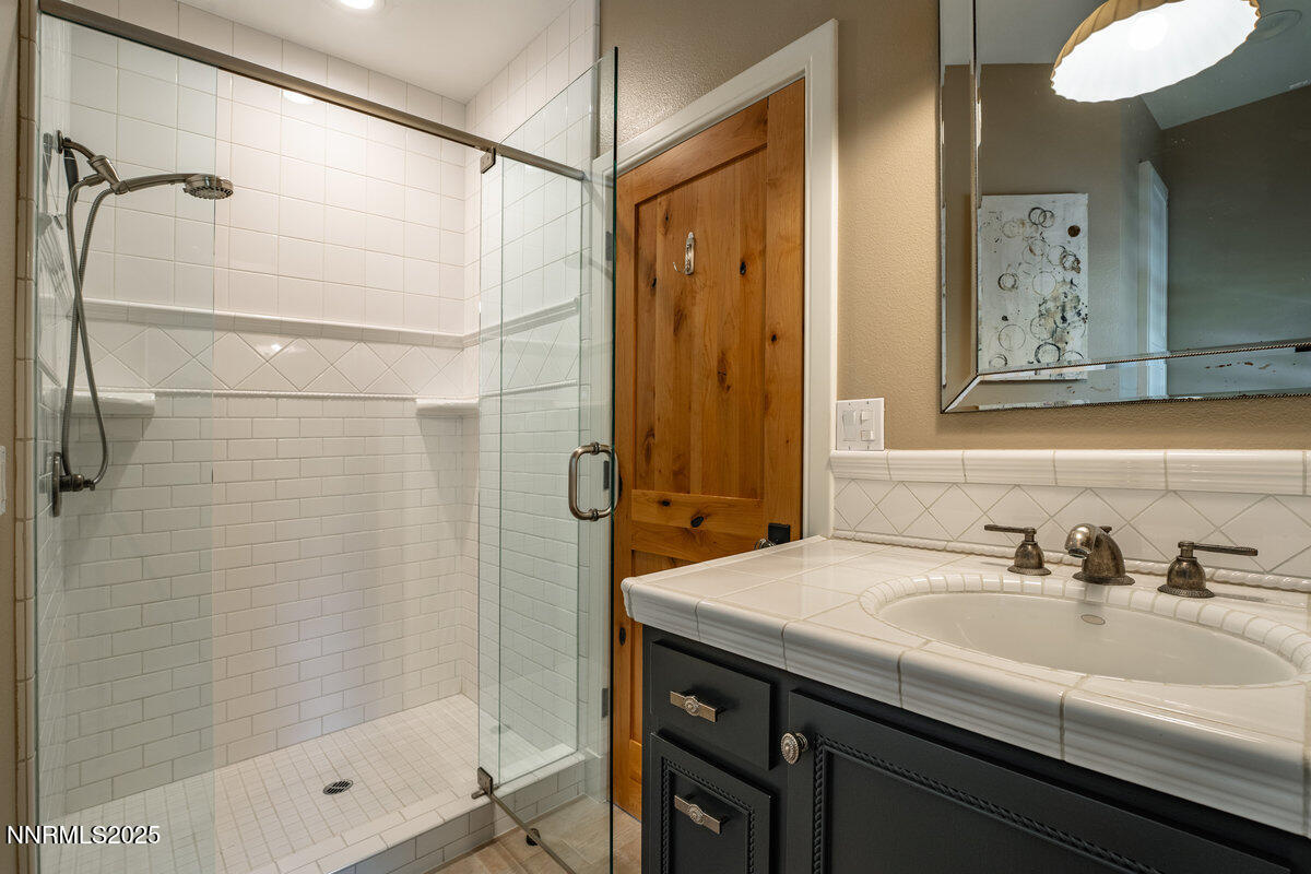 2 South Point Place Glenbrook, NV 89413 - Photo 39 of 49 a bathroom with a shower sink and mirror