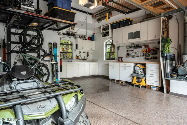 a utility room with dryer bicycles and windows