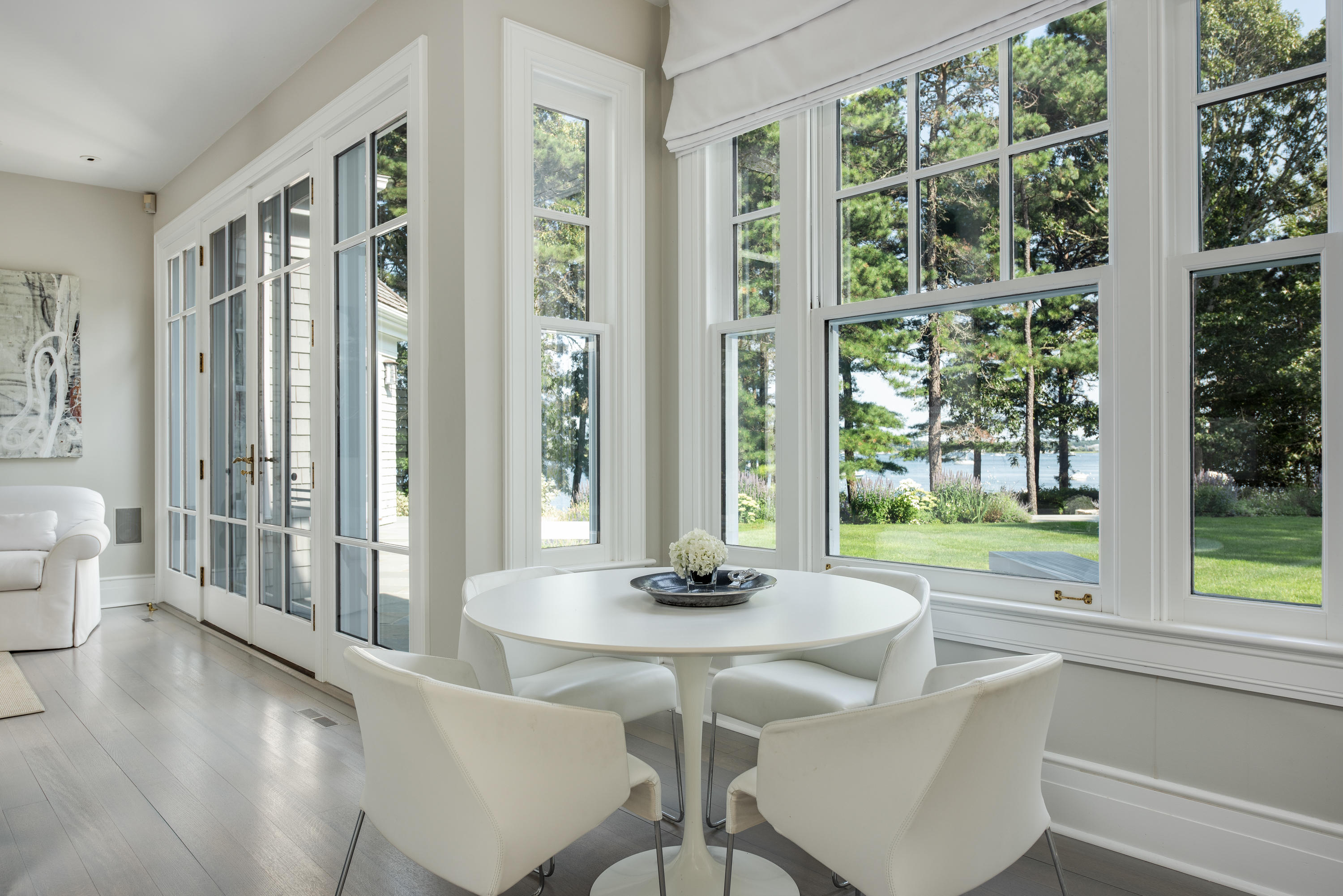 1025 Old Post Road Cotuit, MA 02635 - Photo 13 of 20 a dining room with wooden floor a glass table and chairs