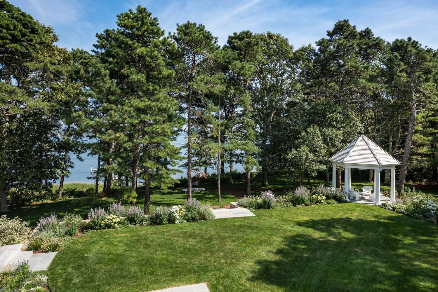 1025 Old Post Road Cotuit, MA 02635 - Photo 15 of 20 a front view of a house with a yard