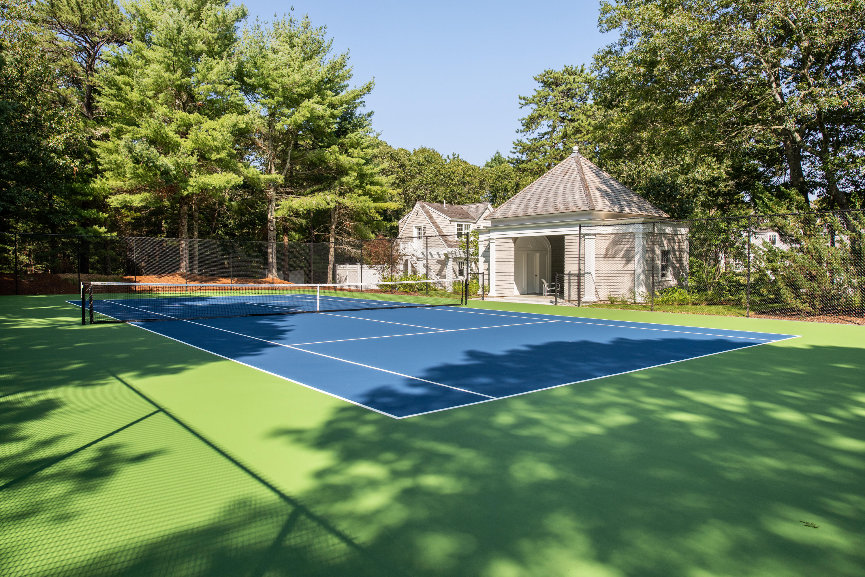 1025 Old Post Road Cotuit, MA 02635 - Photo 17 of 20 a front view of a house with a yard and garage