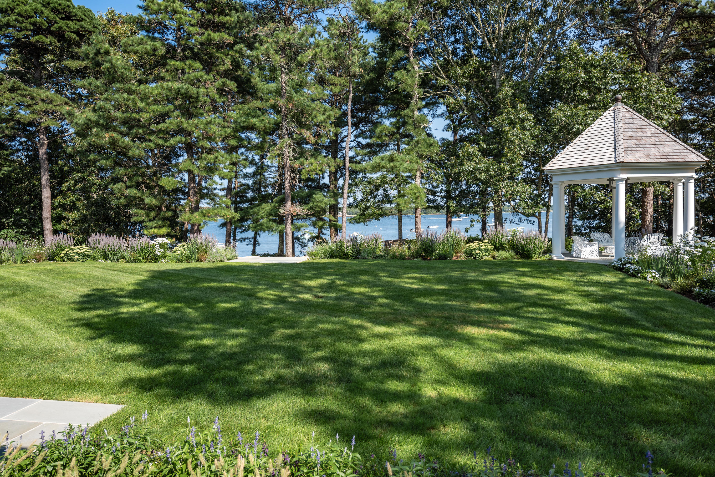 1025 Old Post Road Cotuit, MA 02635 - Photo 3 of 20 a front view of a house with a garden
