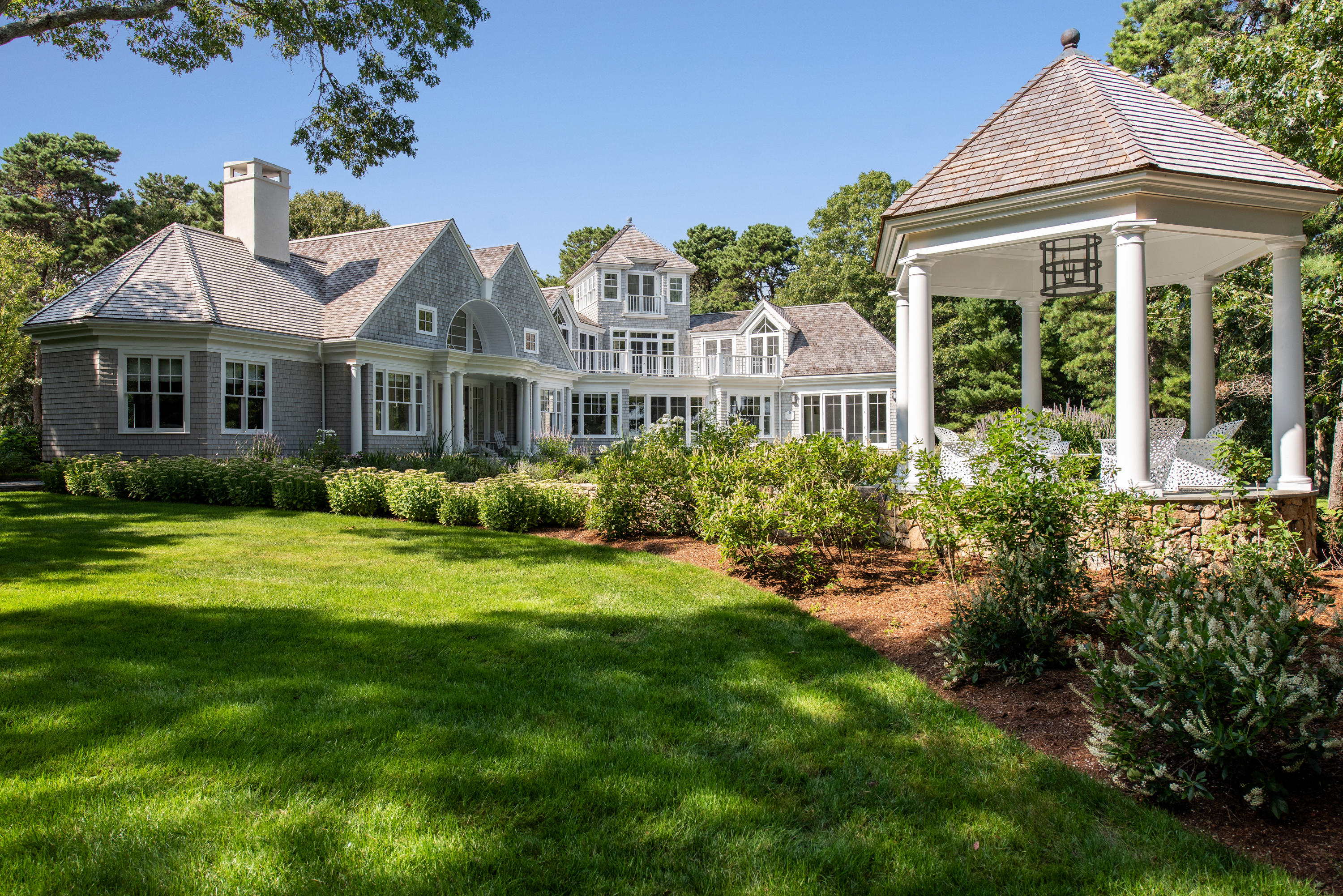 1025 Old Post Road Cotuit, MA 02635 - Photo 6 of 20 a front view of a house with a garden