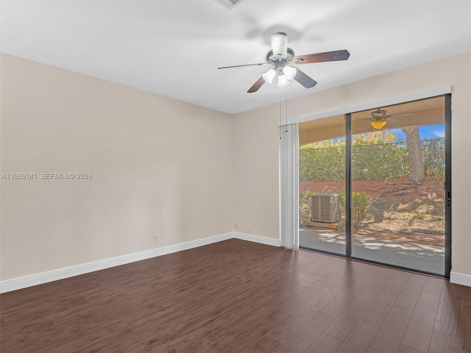 4126 Forest Drive Weston, FL 33332 - Photo 16 of 37 a view of an empty room with wooden floor and a window