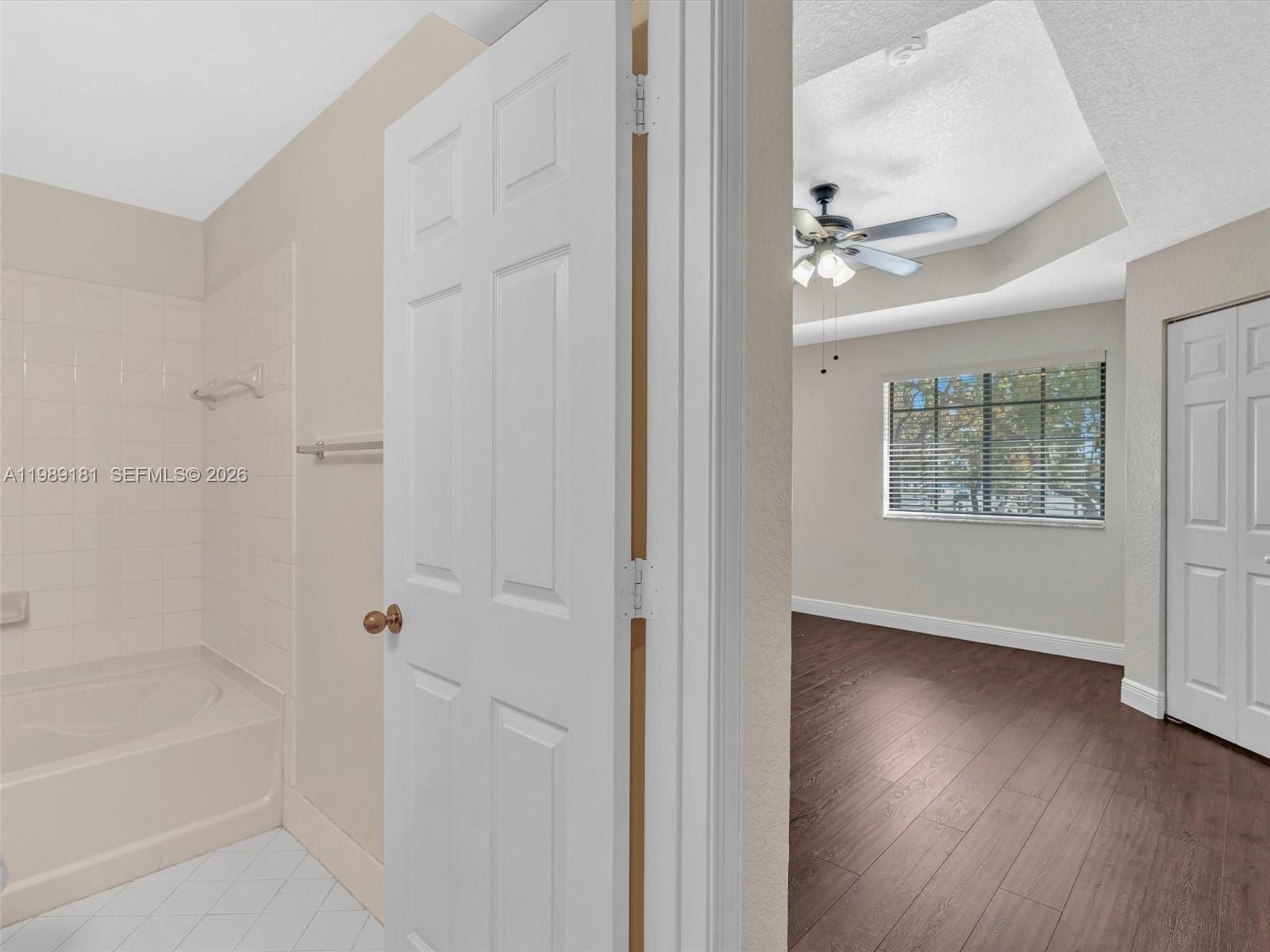 4126 Forest Drive Weston, FL 33332 - Photo 24 of 37 a view of an empty room with wooden floor and a window