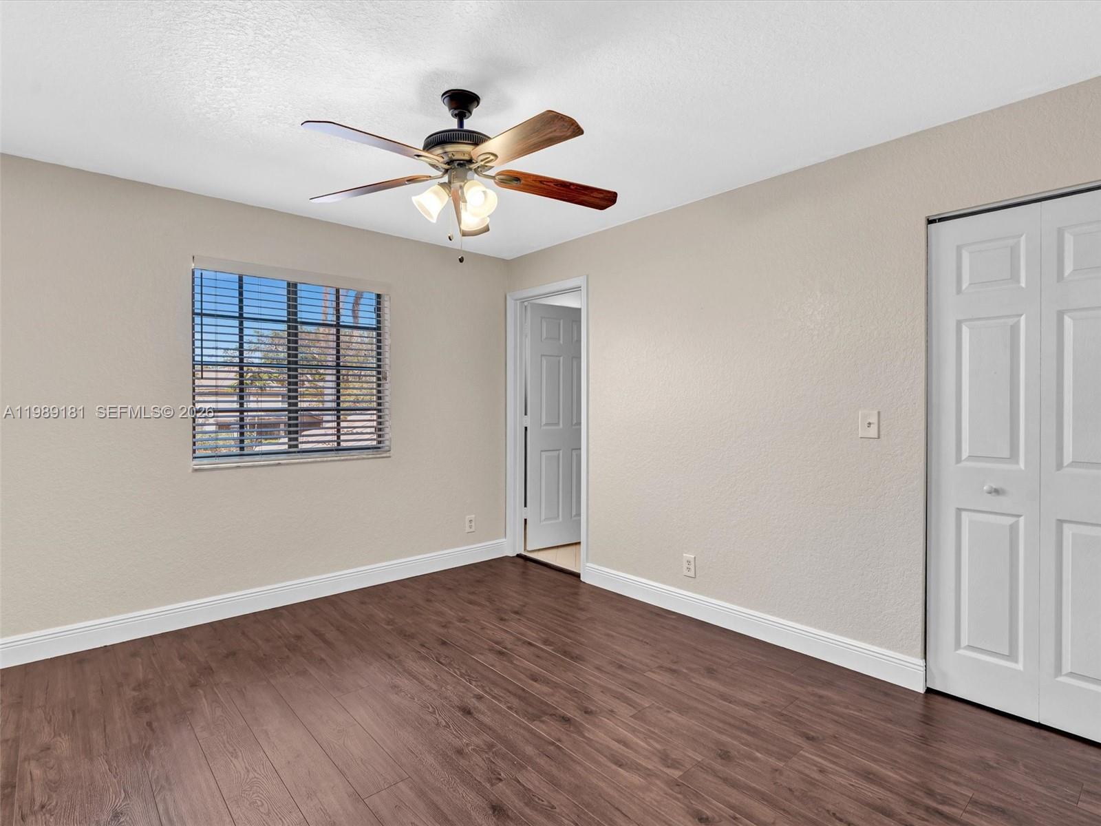 4126 Forest Drive Weston, FL 33332 - Photo 27 of 37 a view of an empty room with wooden floor and a window