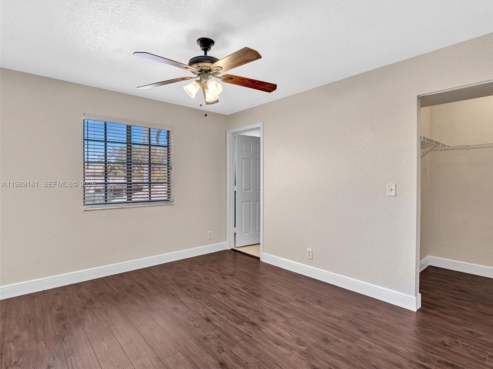 4126 Forest Drive Weston, FL 33332 - Photo 28 of 37 a view of an empty room with wooden floor and a window