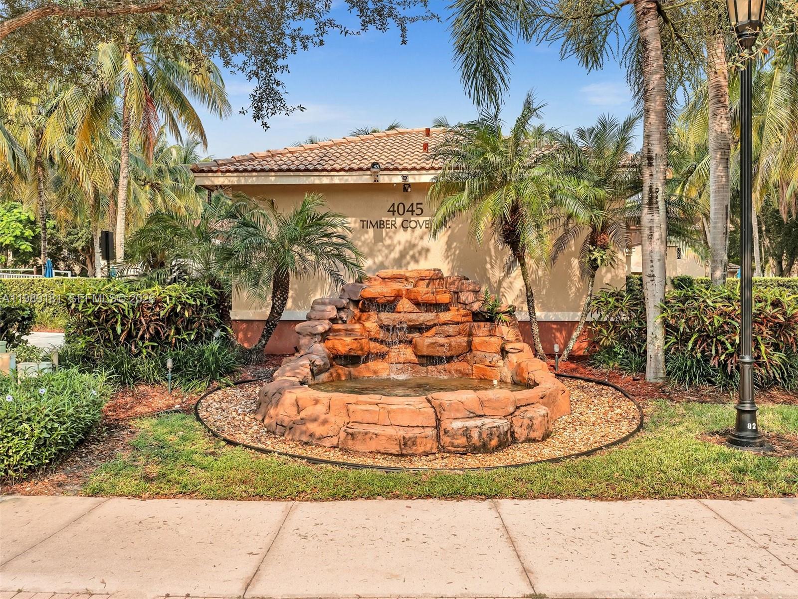 4126 Forest Drive Weston, FL 33332 - Photo 34 of 37 a view of a water fountain with palm trees
