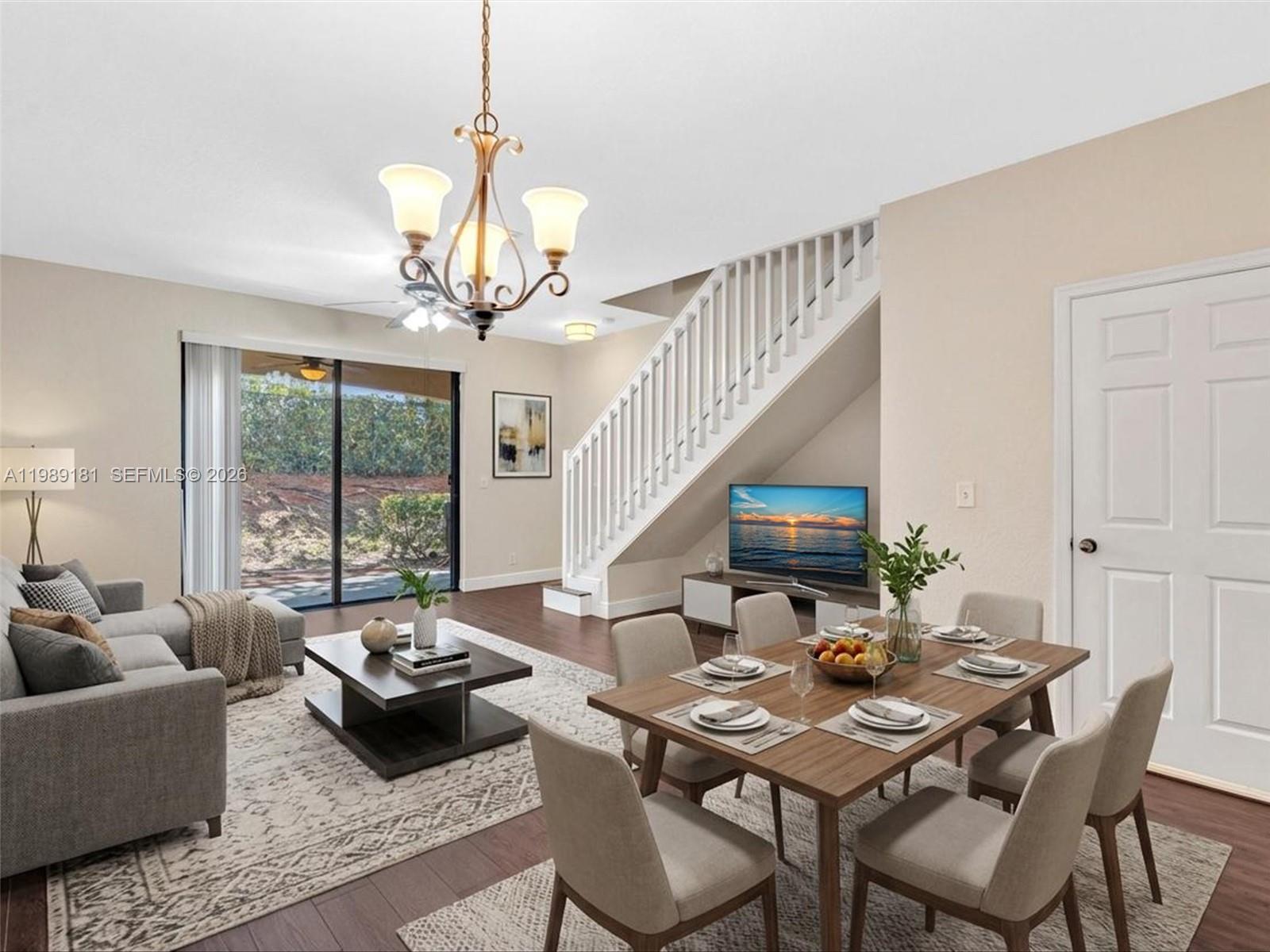4126 Forest Drive Weston, FL 33332 - Photo 8 of 37 a living room with furniture and a chandelier