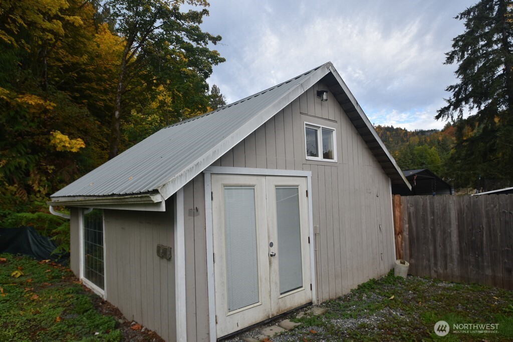 7490 Mill Avenue Concrete, WA 98237 - Photo 23 of 35 a house with trees in the background