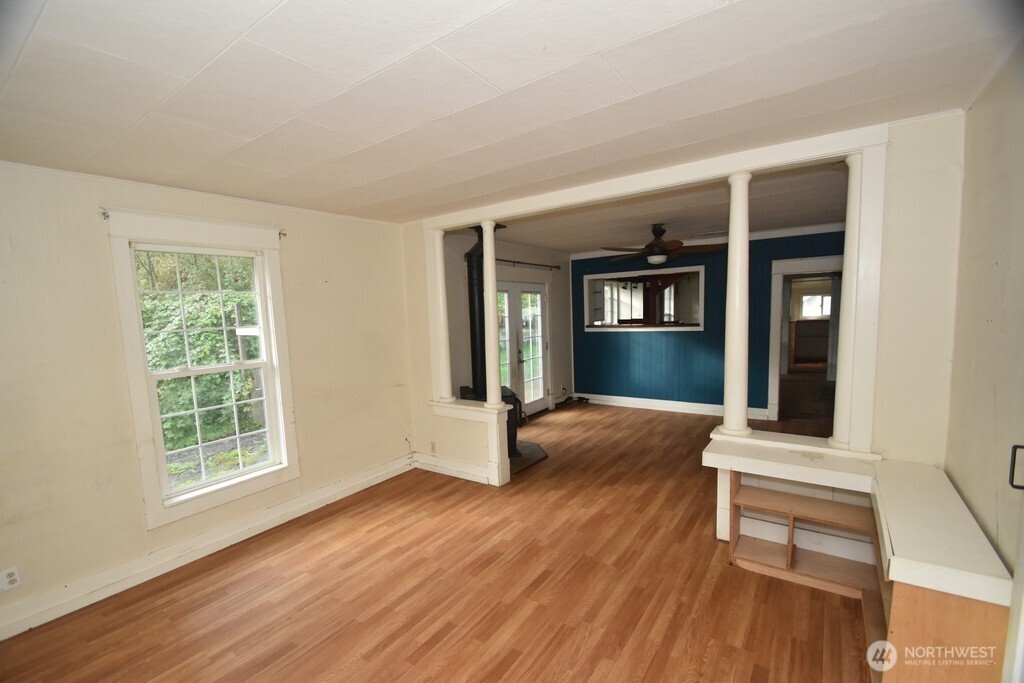7490 Mill Avenue Concrete, WA 98237 - Photo 3 of 35 a view of an empty room with wooden floor and a window