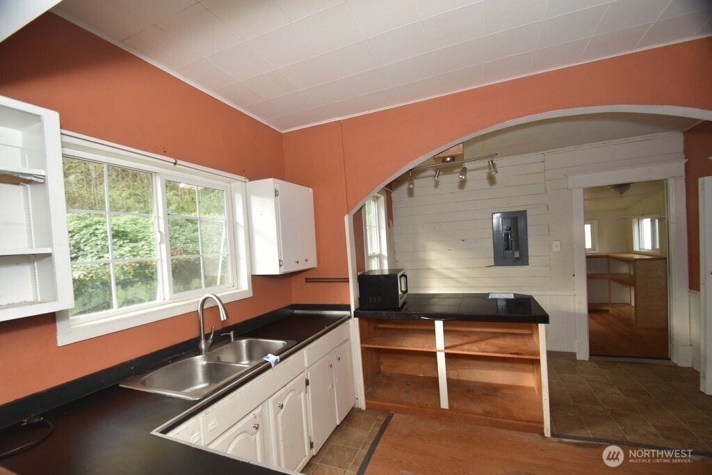 7490 Mill Avenue Concrete, WA 98237 - Photo 9 of 35 a kitchen with granite countertop a stove and a sink