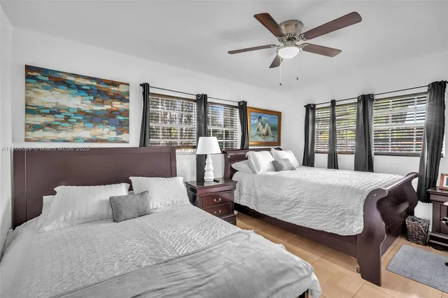 a bedroom with bed and glass window