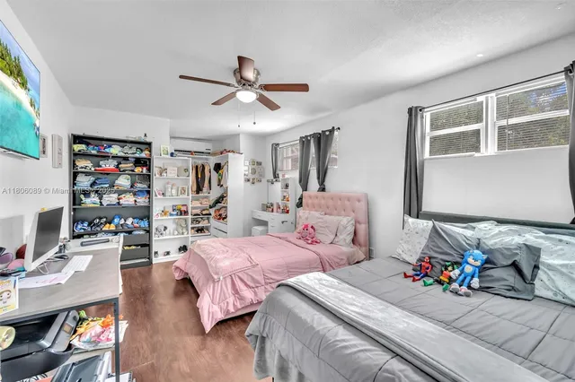 a bedroom with two beds and a chandelier