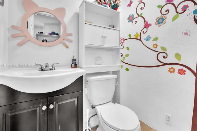 a bathroom with a sink a mirror and a toilet