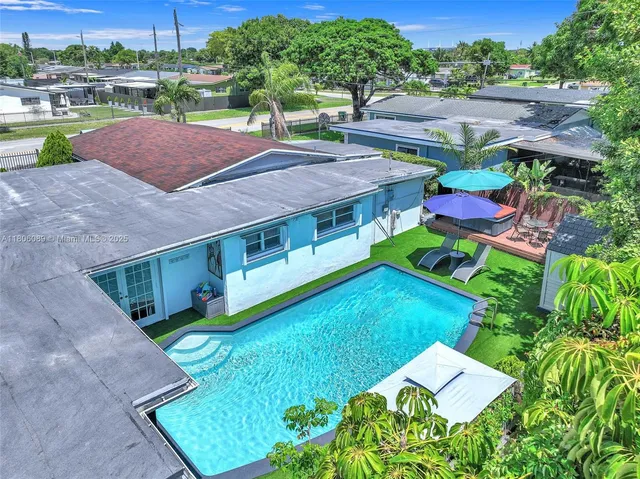 an aerial view of a house with pool patio and outdoor seating