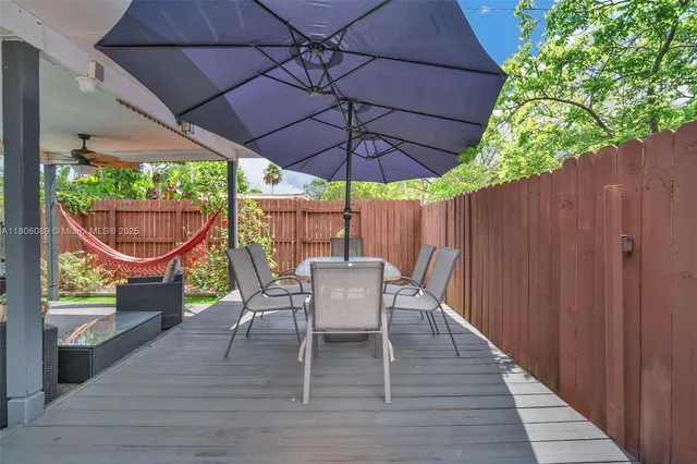 an aerial view of a house with a yard and a large tree