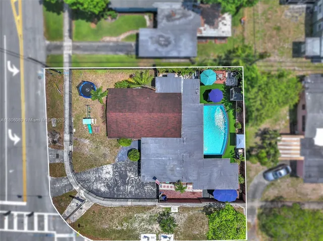 an aerial view of multiple houses with a yard