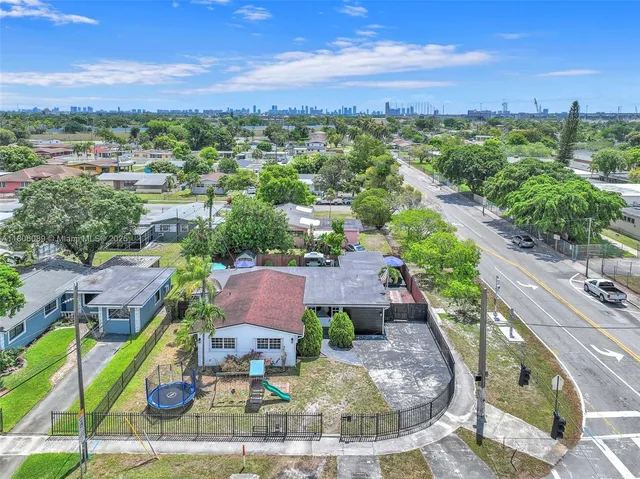 a view of a patio with table and chairs under an umbrella