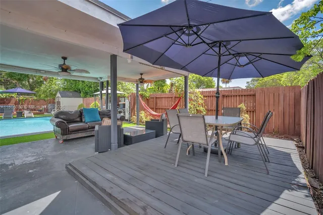 a view of a backyard with swimming pool