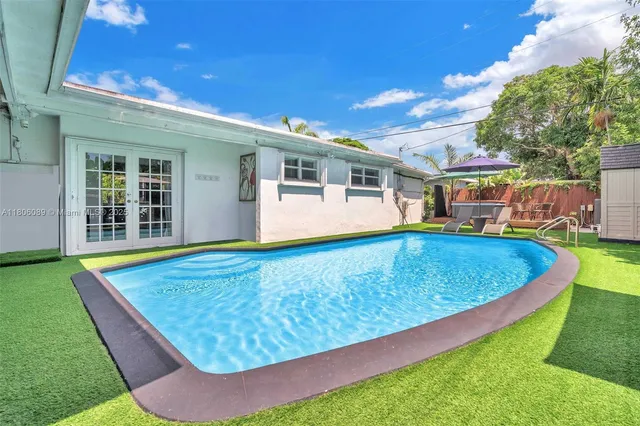 a view of a house with swimming pool and yard