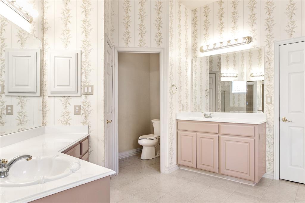 1614 Villa Court Corinth, TX 76210 - Photo 13 of 17 Bathroom featuring two vanities, wallpapered walls, and light tile patterned flooring