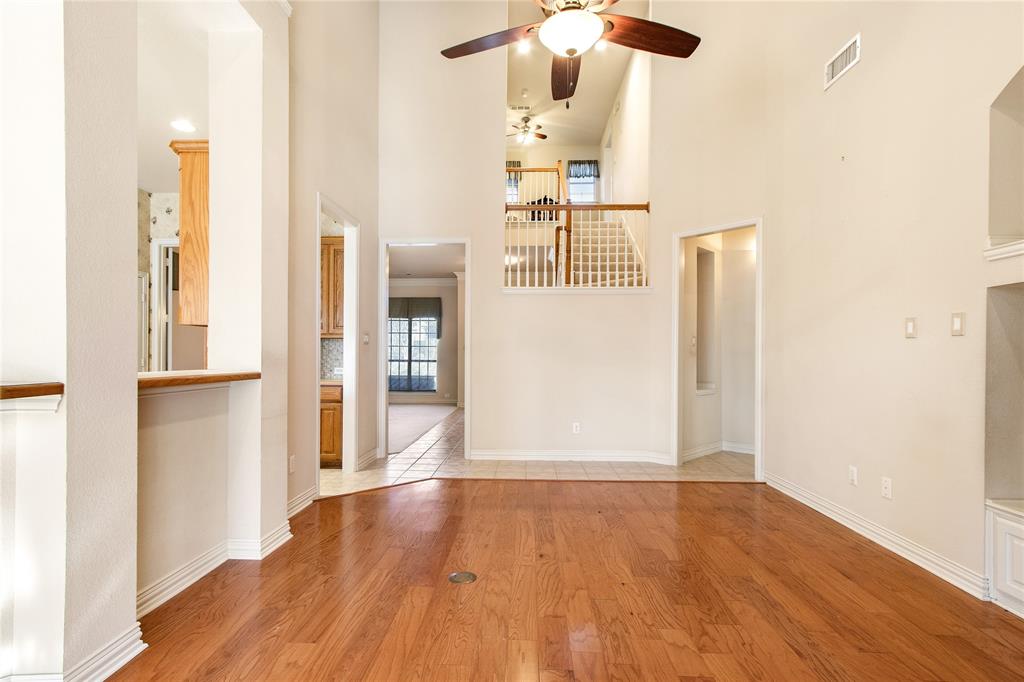 1614 Villa Court Corinth, TX 76210 - Photo 5 of 17 Unfurnished living room with a ceiling fan, high vaulted ceiling, and light wood finished floors